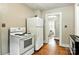 Kitchen showcasing a white refrigerator and oven set, with original hardwood flooring at 450 1St Se St, Hickory, NC 28602