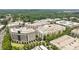 An aerial view of multiple luxury apartment buildings surrounded by lush trees and landscaping at 4625 Piedmont Row Dr, Charlotte, NC 28210
