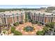 Aerial view of building with fountain in a circular driveway with trees and Charlotte, NC skyline in background at 4625 Piedmont Row Dr, Charlotte, NC 28210