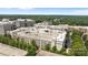 An aerial view shows a large residential and commercial building with a parking deck, with trees around the property at 4625 Piedmont Row Dr, Charlotte, NC 28210