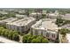 An aerial view of a large luxury residential and commercial real estate community surrounded by trees at 4625 Piedmont Row Dr, Charlotte, NC 28210