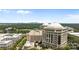 The city view showcases the building complex with lush greenery and skyline in the distance on a sunny day at 4625 Piedmont Row Dr, Charlotte, NC 28210