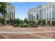Low angle exterior shot of large building with water fountain and manicured landscaping at 4625 Piedmont Row Dr, Charlotte, NC 28210
