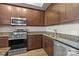 Kitchen area with stainless steel oven, microwave, dishwasher and granite countertops at 4625 Piedmont Row Dr, Charlotte, NC 28210