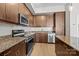 Bright kitchen with stainless steel appliances, granite countertops and wood cabinets at 4625 Piedmont Row Dr, Charlotte, NC 28210