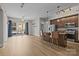 Spacious living room with hardwood floors, a ceiling fan and a modern kitchen at 4625 Piedmont Row Dr, Charlotte, NC 28210