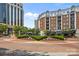 The street view features a roundabout with a fountain, framed by brick buildings and lush landscaping at 4625 Piedmont Row Dr, Charlotte, NC 28210