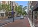 The street view shows the building's facade and street with lamp posts, trees, and several parked cars at 4625 Piedmont Row Dr, Charlotte, NC 28210