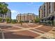 A street level view of a beautiful community showing shops, sidewalks, and lush plantings at 4625 Piedmont Row Dr, Charlotte, NC 28210