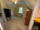 Open attic space with furniture, a window, and a doorway at 5024 Ardenwoods Dr, Charlotte, NC 28215