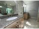 Bathroom featuring granite counter vanity, modern fixtures, a tiled floor and a nice mirror at 5024 Ardenwoods Dr, Charlotte, NC 28215
