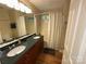 Bathroom featuring a double sink vanity with wood cabinets and a shower-tub combo at 5024 Ardenwoods Dr, Charlotte, NC 28215