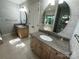 Bathroom featuring dual granite vanities, modern fixtures, and tiled floors at 5024 Ardenwoods Dr, Charlotte, NC 28215