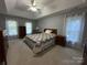 Cozy bedroom featuring a tray ceiling, neutral walls, and lots of natural light at 5024 Ardenwoods Dr, Charlotte, NC 28215
