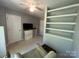 Bedroom featuring built-in shelves, a ceiling fan, and neutral walls at 5024 Ardenwoods Dr, Charlotte, NC 28215