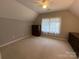 Large bedroom featuring neutral carpeting, a window, and dark wood furnishings at 5024 Ardenwoods Dr, Charlotte, NC 28215
