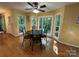 Bright breakfast area featuring hardwood floors, a cozy dining table, and large windows offering serene views of the surrounding trees at 5024 Ardenwoods Dr, Charlotte, NC 28215