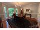 Bright dining room with hardwood floors, a bay window, and a traditional table setting at 5024 Ardenwoods Dr, Charlotte, NC 28215