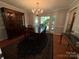 Elegant dining room showcasing a bay window, chandelier, and dark wood furnishings at 5024 Ardenwoods Dr, Charlotte, NC 28215