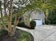 Spacious two-car garage with a white door and a well-manicured lawn at 5024 Ardenwoods Dr, Charlotte, NC 28215