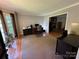 Home office with ample natural light, a computer, and convenient access to the living room at 5024 Ardenwoods Dr, Charlotte, NC 28215