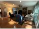 Spacious living room featuring a cozy fireplace, hardwood floors, and large windows at 5024 Ardenwoods Dr, Charlotte, NC 28215