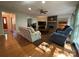 Inviting living room with a brick fireplace, wood floors, and a ceiling fan for added comfort at 5024 Ardenwoods Dr, Charlotte, NC 28215
