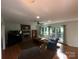 Spacious living room featuring a cozy fireplace, hardwood floors, and large windows at 5024 Ardenwoods Dr, Charlotte, NC 28215