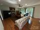 Spacious living room featuring a cozy fireplace, hardwood floors, and large windows at 5024 Ardenwoods Dr, Charlotte, NC 28215