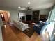 Comfortable living room featuring a brick fireplace, hardwood floors, and cozy seating at 5024 Ardenwoods Dr, Charlotte, NC 28215