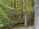 Storage shed nestled in the wooded backyard, providing ample space for tools and equipment at 5024 Ardenwoods Dr, Charlotte, NC 28215