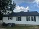 Rear view of updated house featuring replacement windows and large yard at 508 E Rice St, Landis, NC 28088