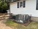 Side of house featuring modern HVAC system on mulched pad, with fencing at 508 E Rice St, Landis, NC 28088