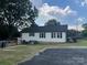 Rear view of charming home with large yard, mature trees, and spacious driveway at 508 E Rice St, Landis, NC 28088