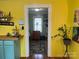 Yellow kitchen leading to an adjacent room with a glimpse of the furniture at 508 E Rice St, Landis, NC 28088