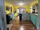 Spacious kitchen with wood flooring, an island, and colorful walls and cabinetry at 508 E Rice St, Landis, NC 28088
