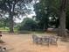 Spacious backyard features mature trees, an outdoor seating area, and recreational equipment at 508 E Rice St, Landis, NC 28088