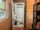 A quaint bathroom with hardwood flooring, wood paneled walls, a walk-in shower, and a toilet at 508 E Rice St, Landis, NC 28088