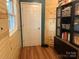 The hallway features hardwood flooring, wood paneled walls, and a black storage cabinet at 508 E Rice St, Landis, NC 28088