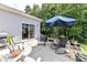 View of the backyard patio featuring patio chairs, an umbrella, and direct access to home's interior at 5129 Devonshire Rd, Denver, NC 28037