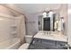 A bathroom featuring a tub and shower combination, toilet, and a vanity at 5129 Devonshire Rd, Denver, NC 28037