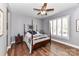 Bedroom featuring a four-poster bed, hardwood floors, ceiling fan, and plantation shutters at 5129 Devonshire Rd, Denver, NC 28037