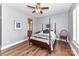 Bedroom boasting a four-poster bed, hardwood floors, ceiling fan and ensuite bath at 5129 Devonshire Rd, Denver, NC 28037