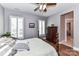Serene bedroom with a ceiling fan, shuttered windows, and an ensuite bathroom entrance at 5129 Devonshire Rd, Denver, NC 28037