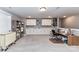 Finished bonus room with white cabinets, shelving, space for crafting, and neutral carpeting at 5129 Devonshire Rd, Denver, NC 28037