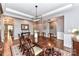 Spacious dining area featuring hardwood floors, coffered ceilings, and an elegant light fixture at 5129 Devonshire Rd, Denver, NC 28037