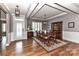 Formal dining room with hardwood floors, coffered ceilings, and ample natural light from the front door at 5129 Devonshire Rd, Denver, NC 28037