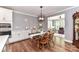 Dining room features a dark wood table with wooden chairs, and is open to the kitchen and living room at 5129 Devonshire Rd, Denver, NC 28037