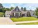 A well-maintained home showcasing a brick exterior, attached garage, lush green lawn, and inviting curb appeal at 5129 Devonshire Rd, Denver, NC 28037
