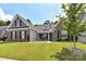 Charming brick home featuring a well-manicured lawn, inviting curb appeal, and decorative stone landscaping at 5129 Devonshire Rd, Denver, NC 28037